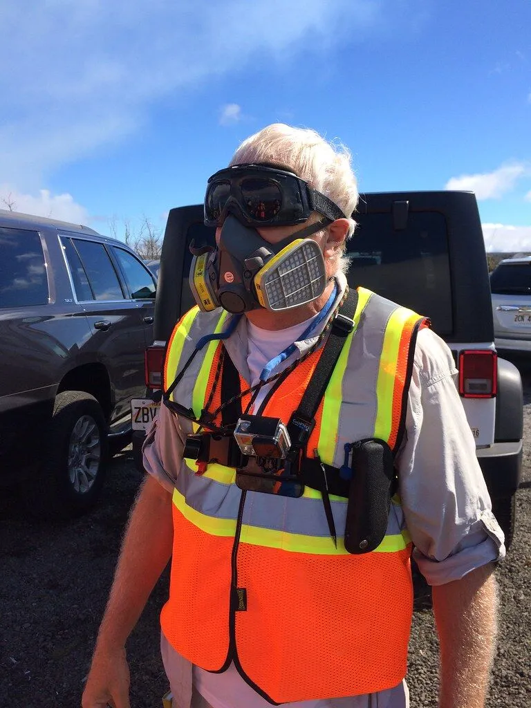 Technician in safety gear conducting field inspection at AutoPartPro facility