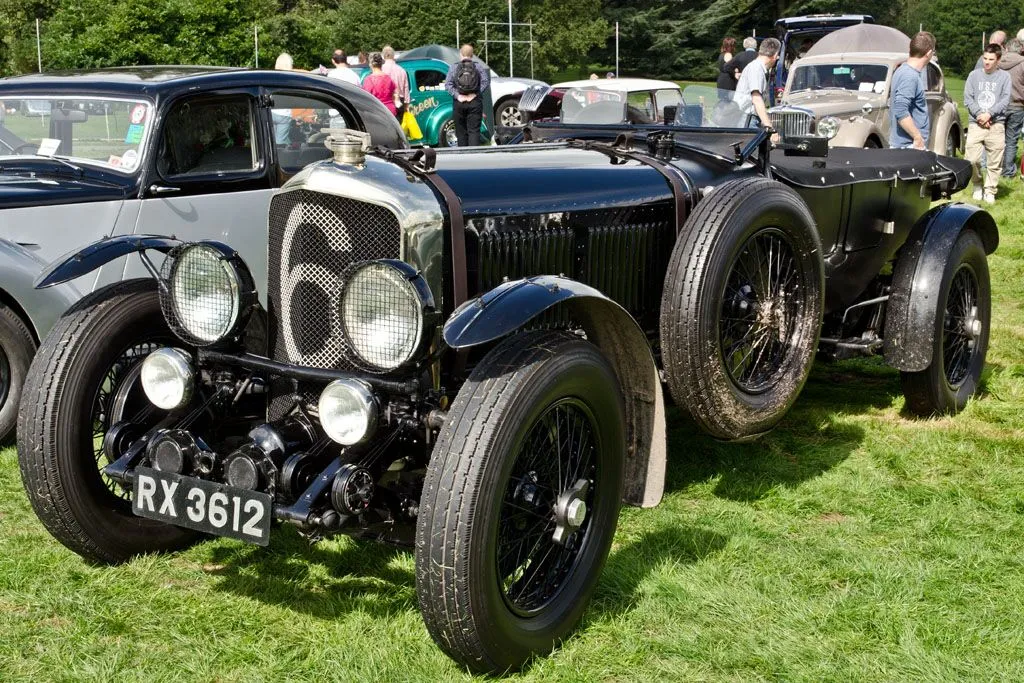 Vintage race car at classic car event, showcasing early automotive design